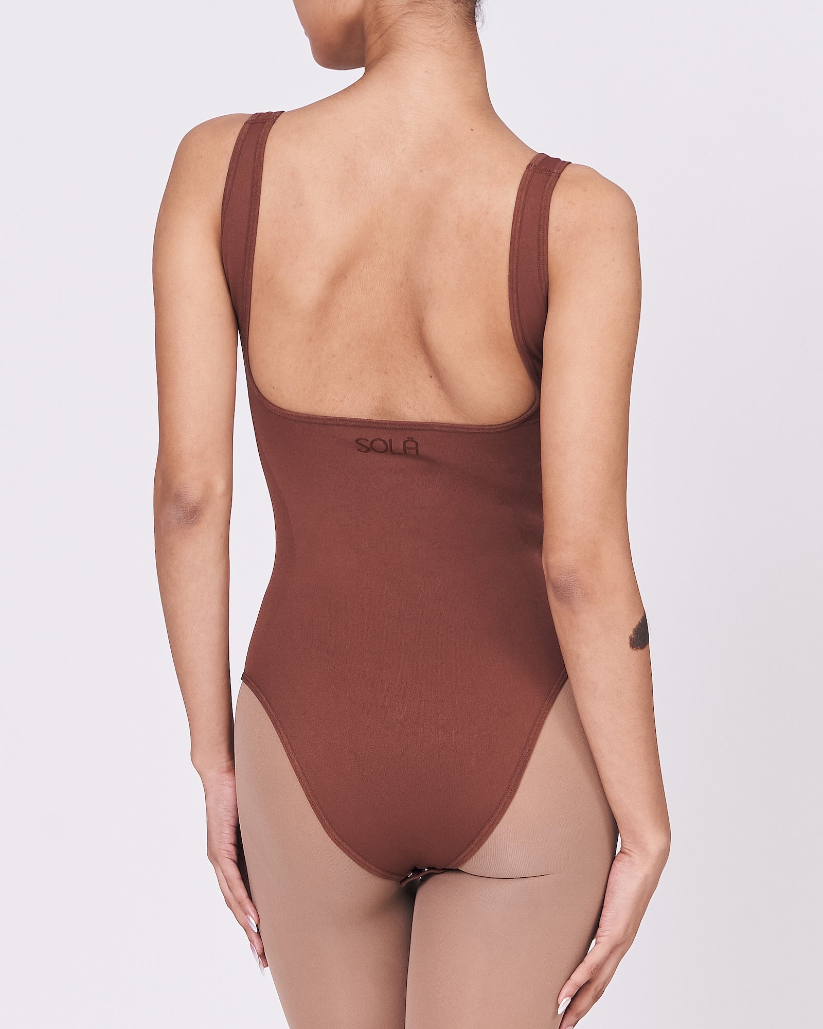 A woman wearing a teddy shapewear