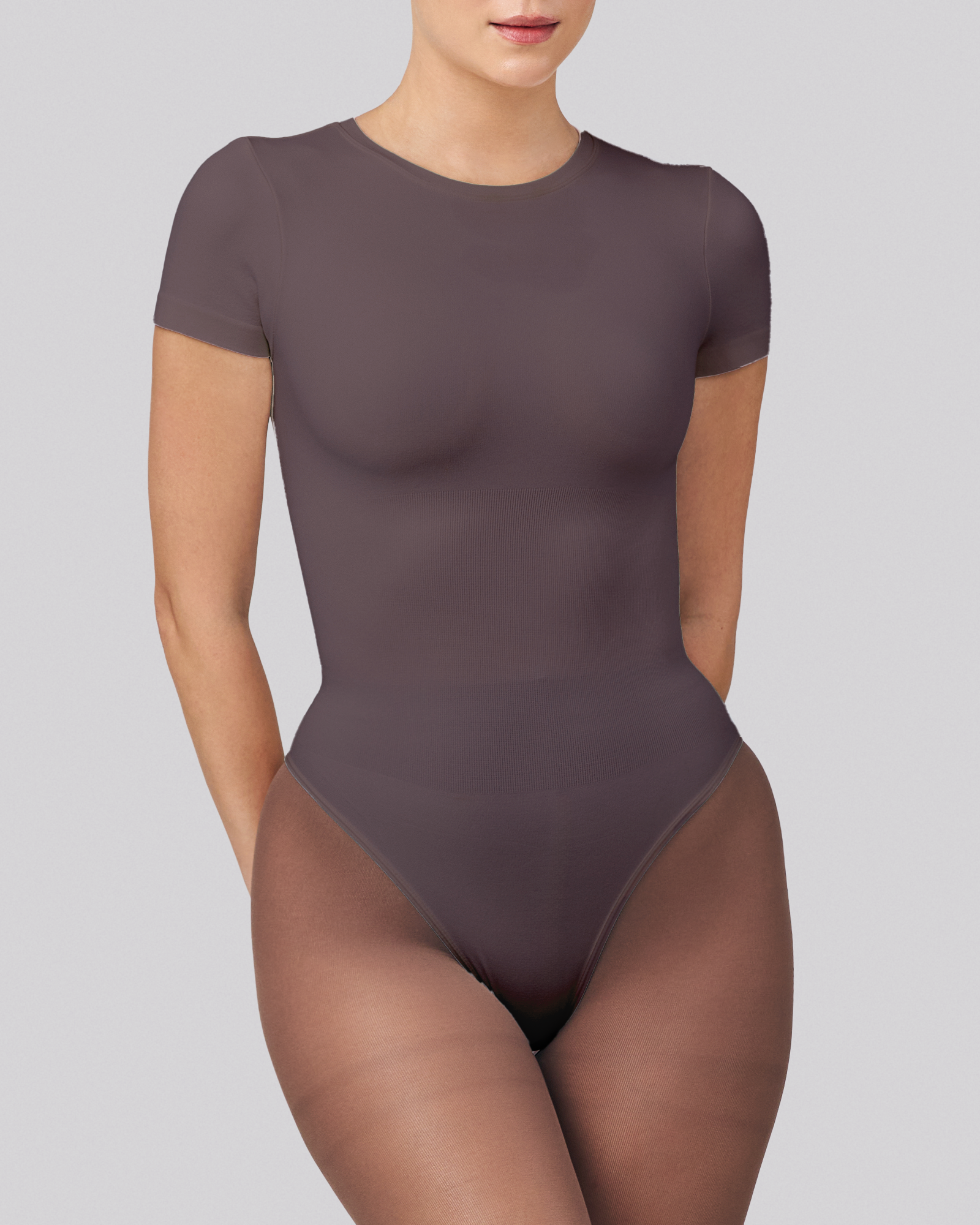 Brown bodysuit worn by a model on a gray background