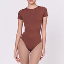 A woman wearing a teddy shapewear